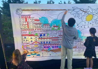 Kids color in a large color by number mural