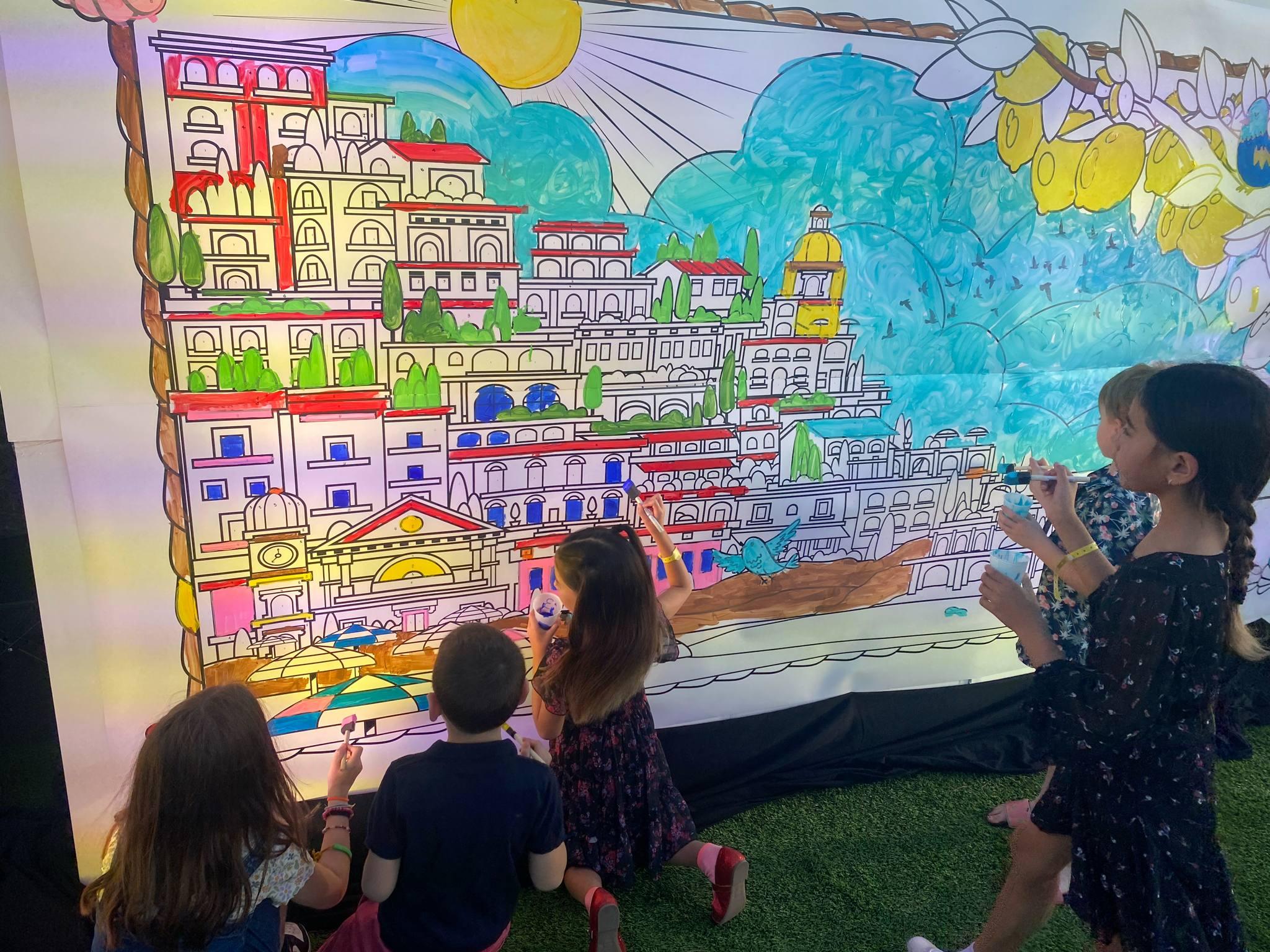 Kids coloring in a mural